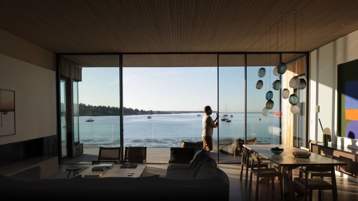 Beach house living room at dusk with the ocean beyond