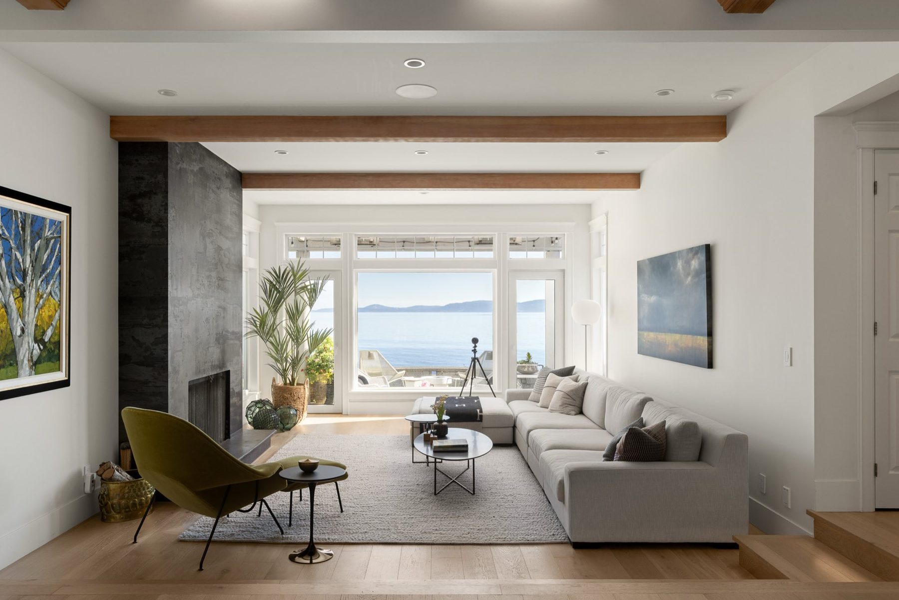 White living room with the ocean beyond the windows