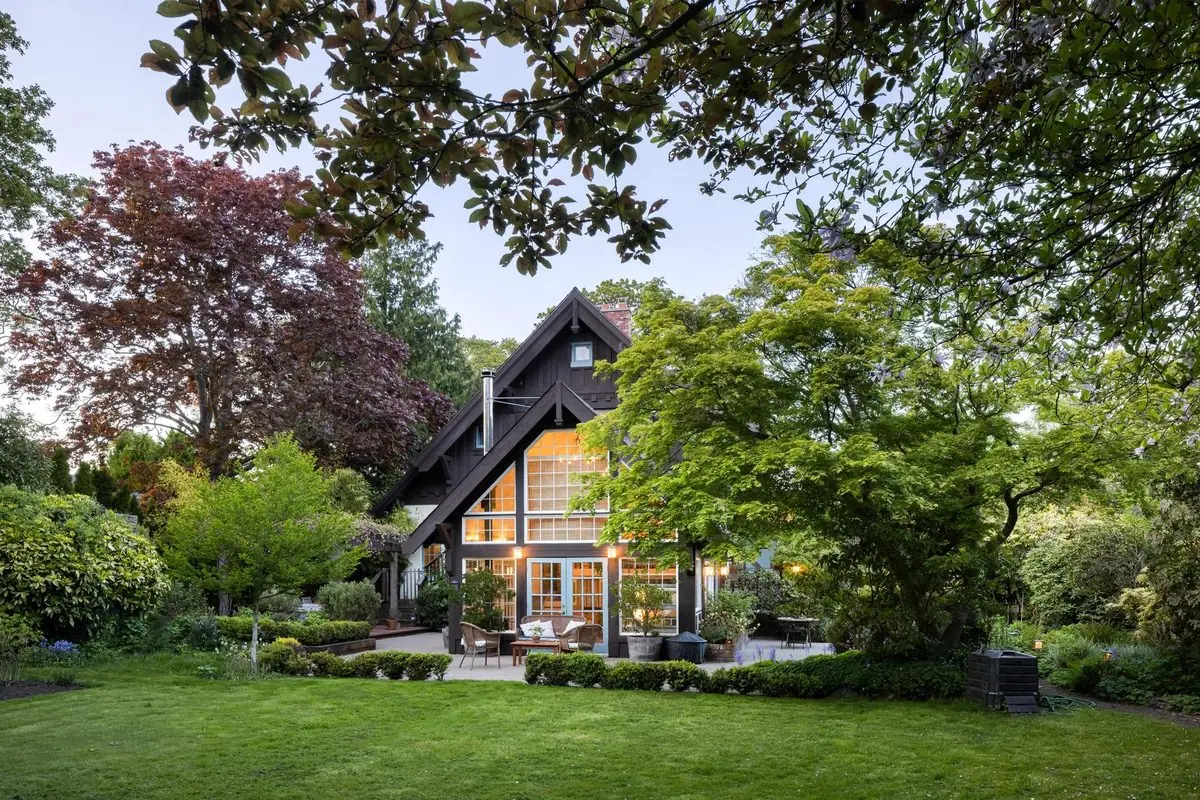 Timber-framed home through the garden at dusk