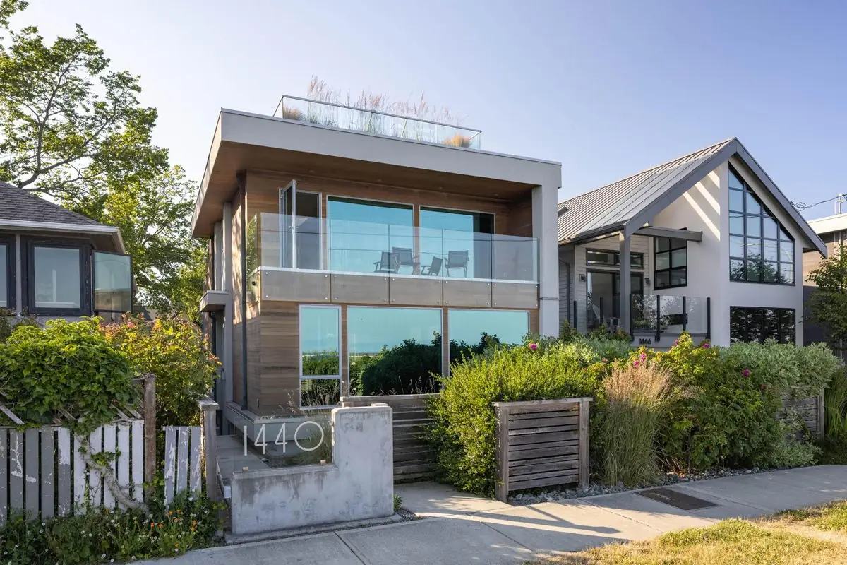 Modern waterfront home with glass balconies