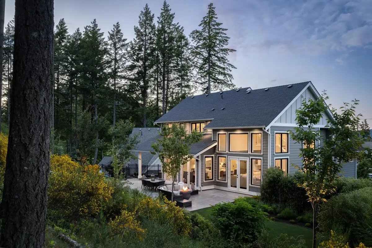 Waterfront home at twilight among arbutus
