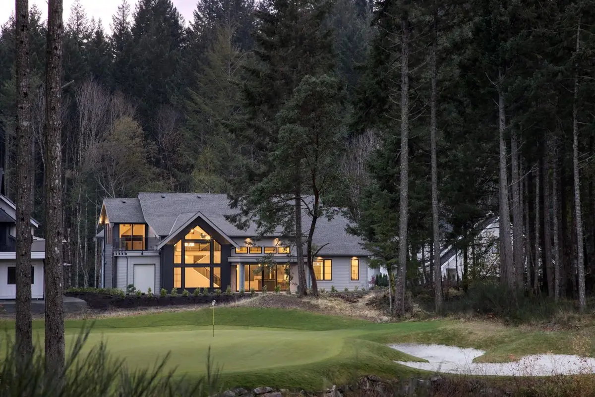 Modern home beside a putting green in the forest