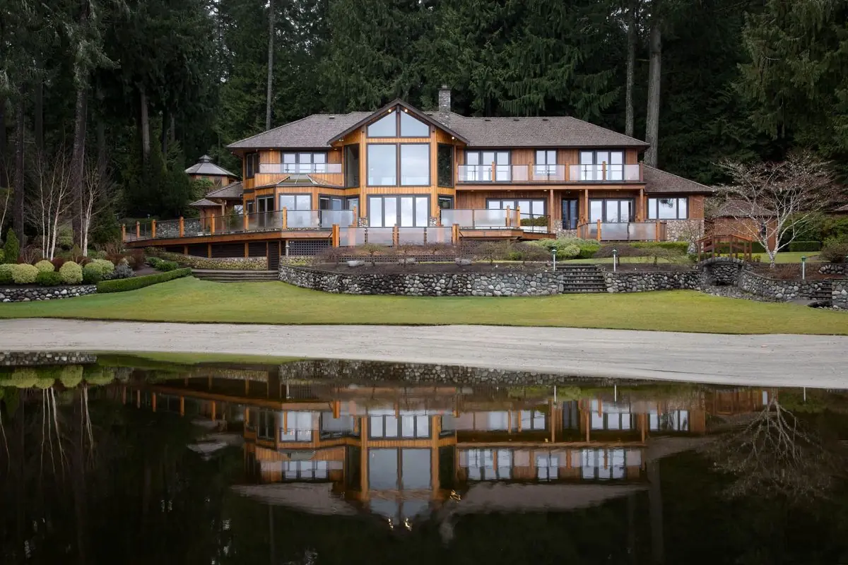 Log home reflected across a pond