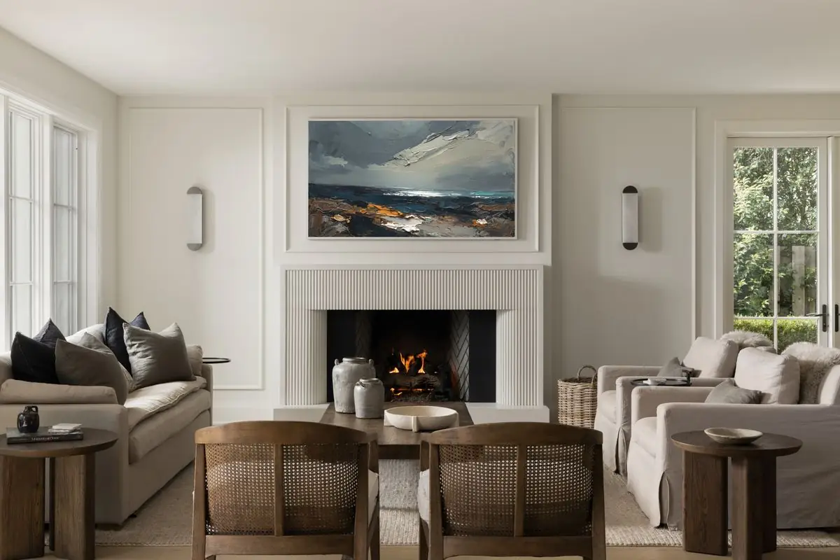 Living room with the fire lit and a seascape above