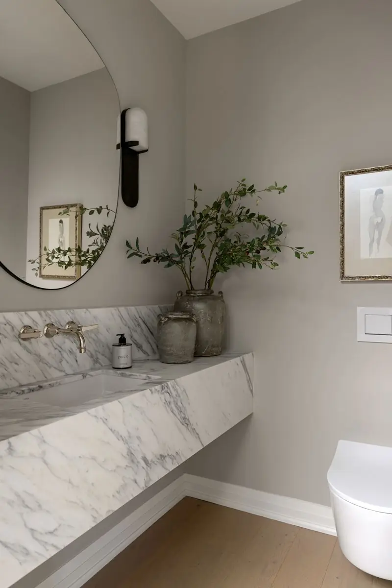 Powder room with a floating marble basin