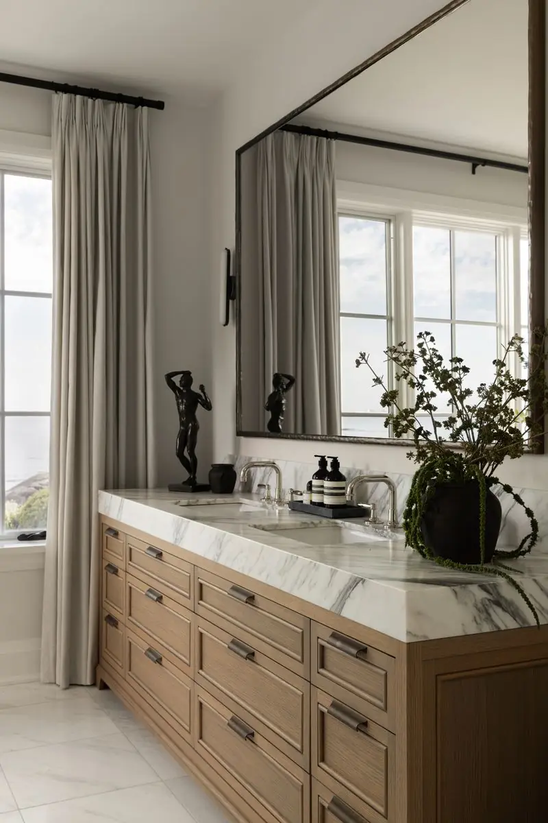 Oak and marble vanity by a curtained window