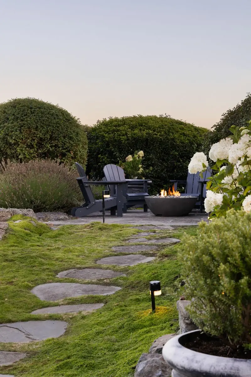 Stepping stones through the moss to a fire bowl