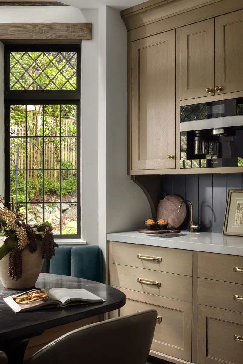 Coffee station in oak cabinetry beside the breakfast nook