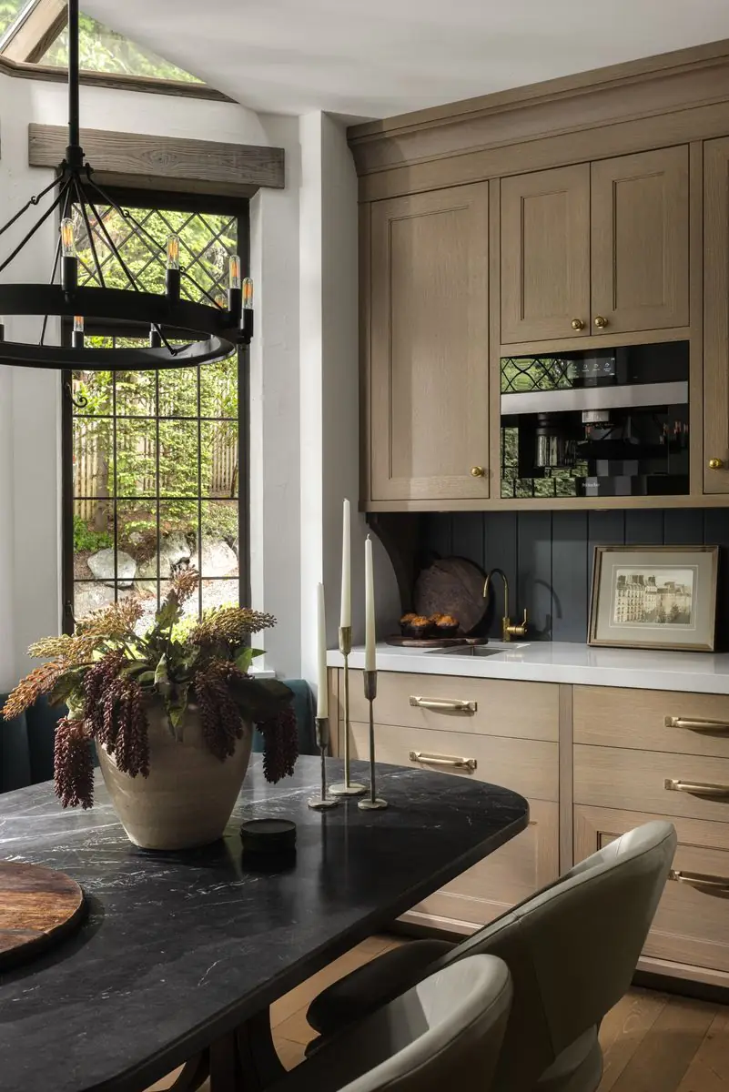Breakfast table under an iron chandelier