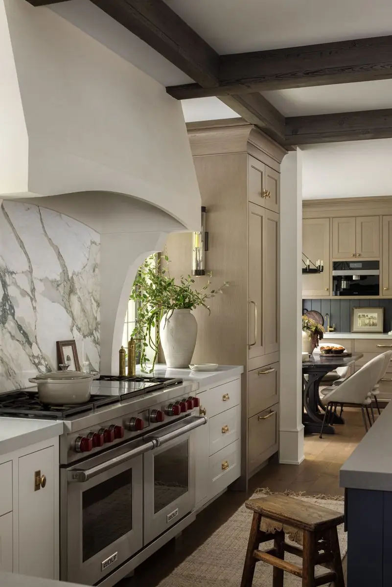 Plaster range hood and marble backsplash, looking toward the dining room
