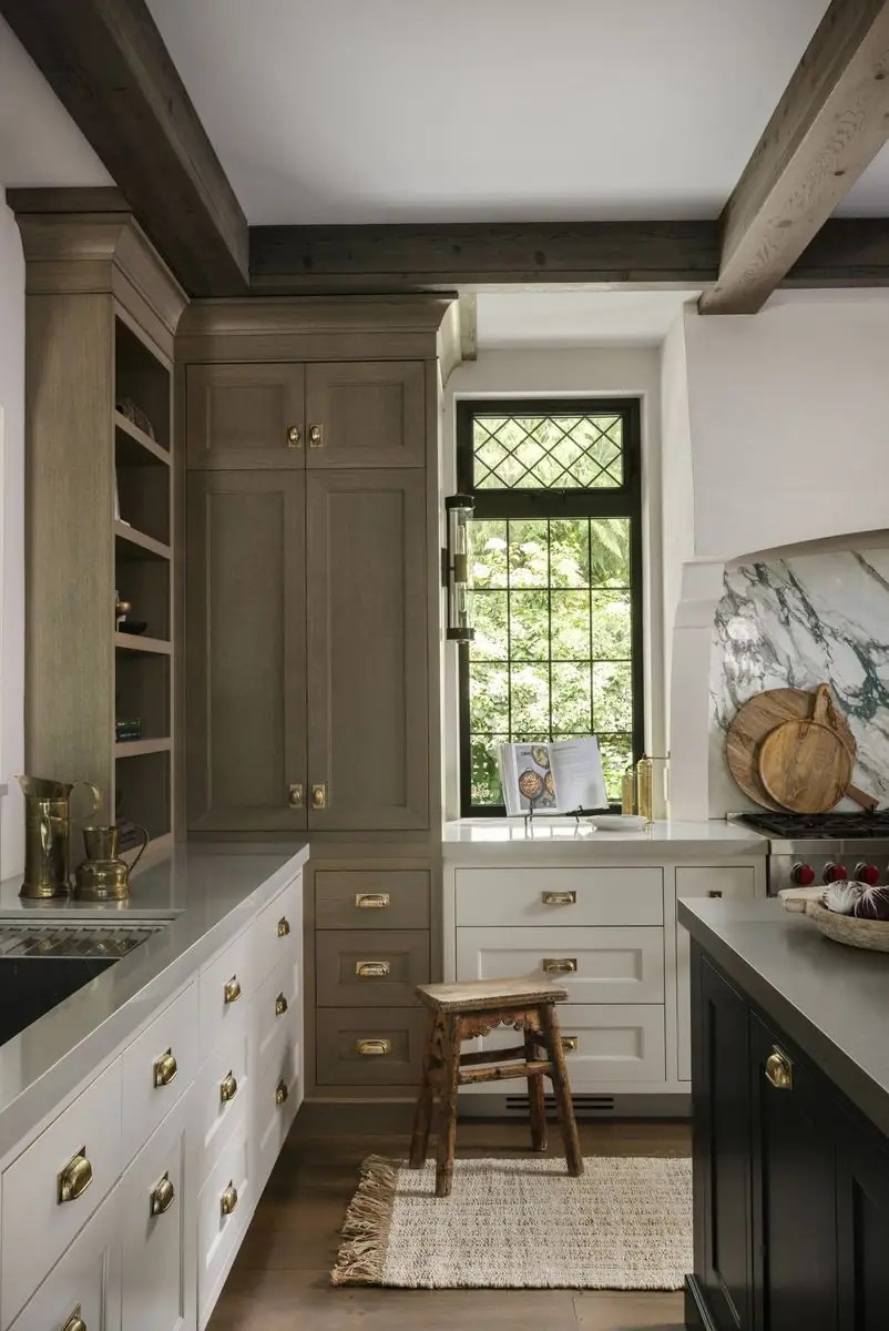 Kitchen with oak cabinets, a leaded window and a wooden stool