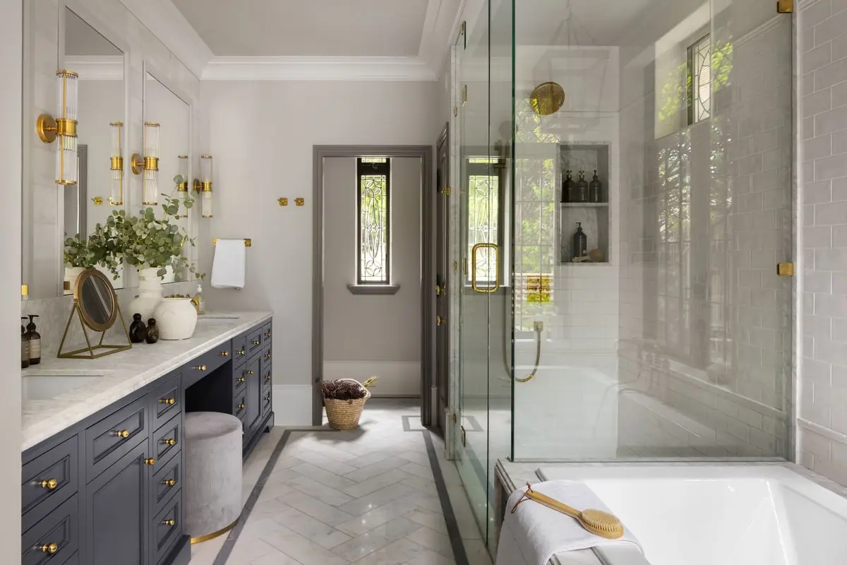 Bathroom with a navy vanity, a glass shower and a tub