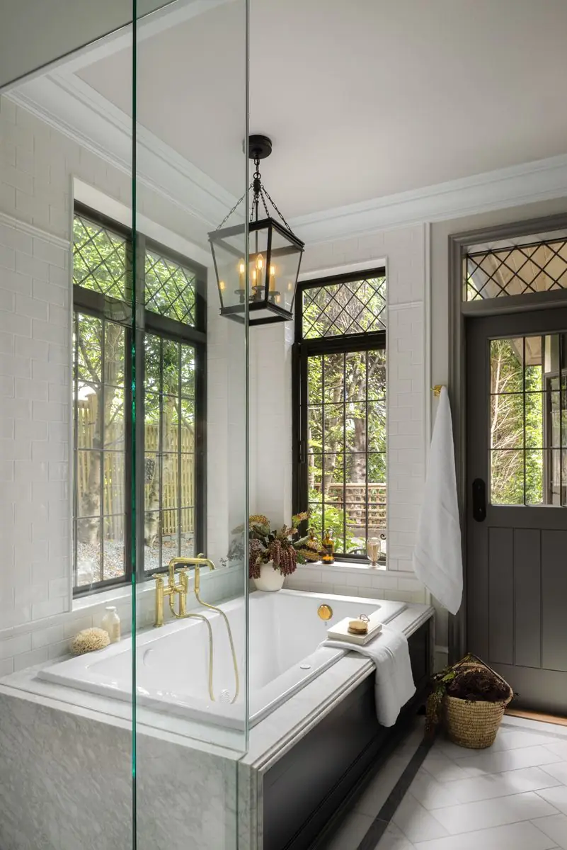 Tub beneath leaded windows and an iron lantern