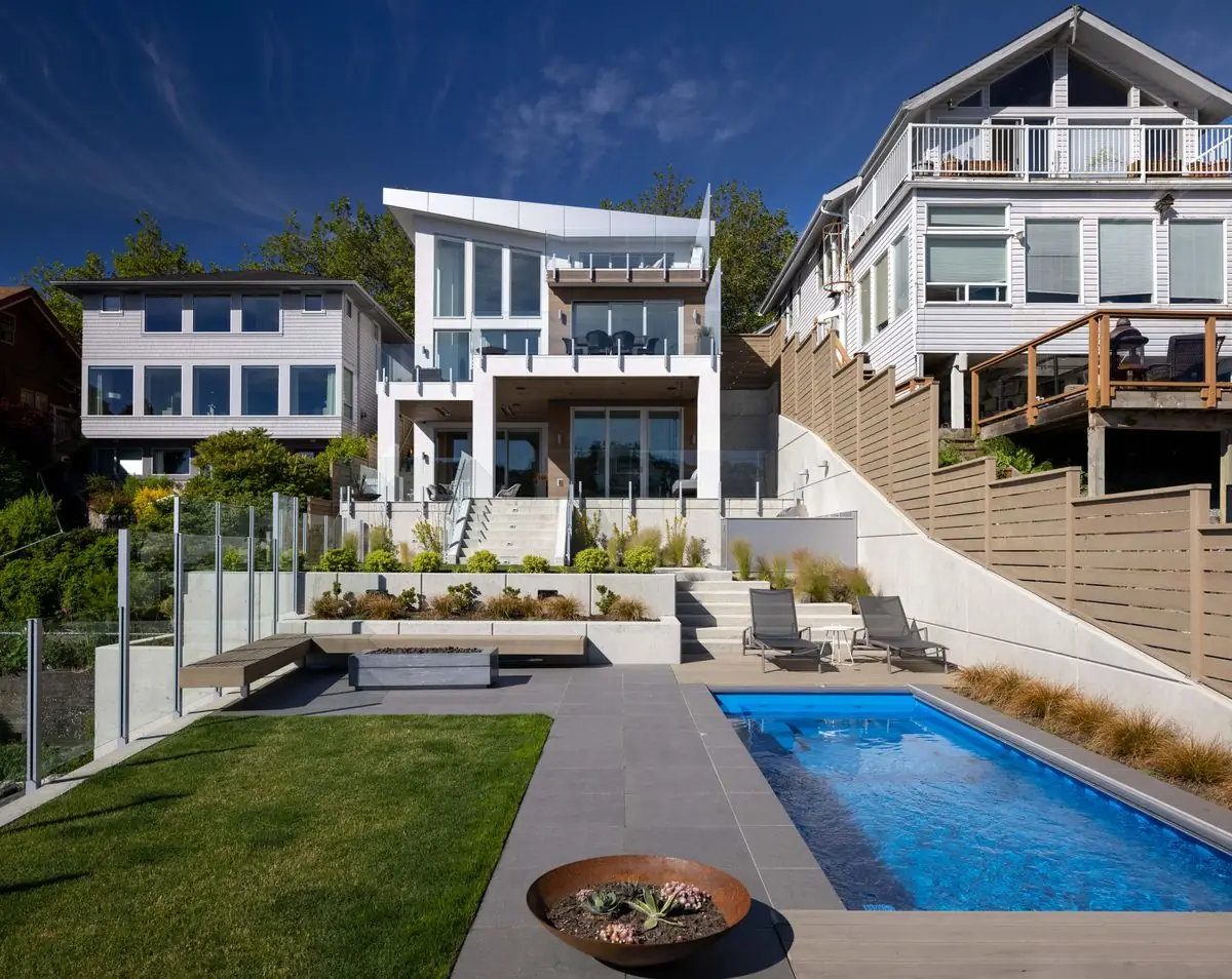 Pool, lawn and terraced garden in the morning sun