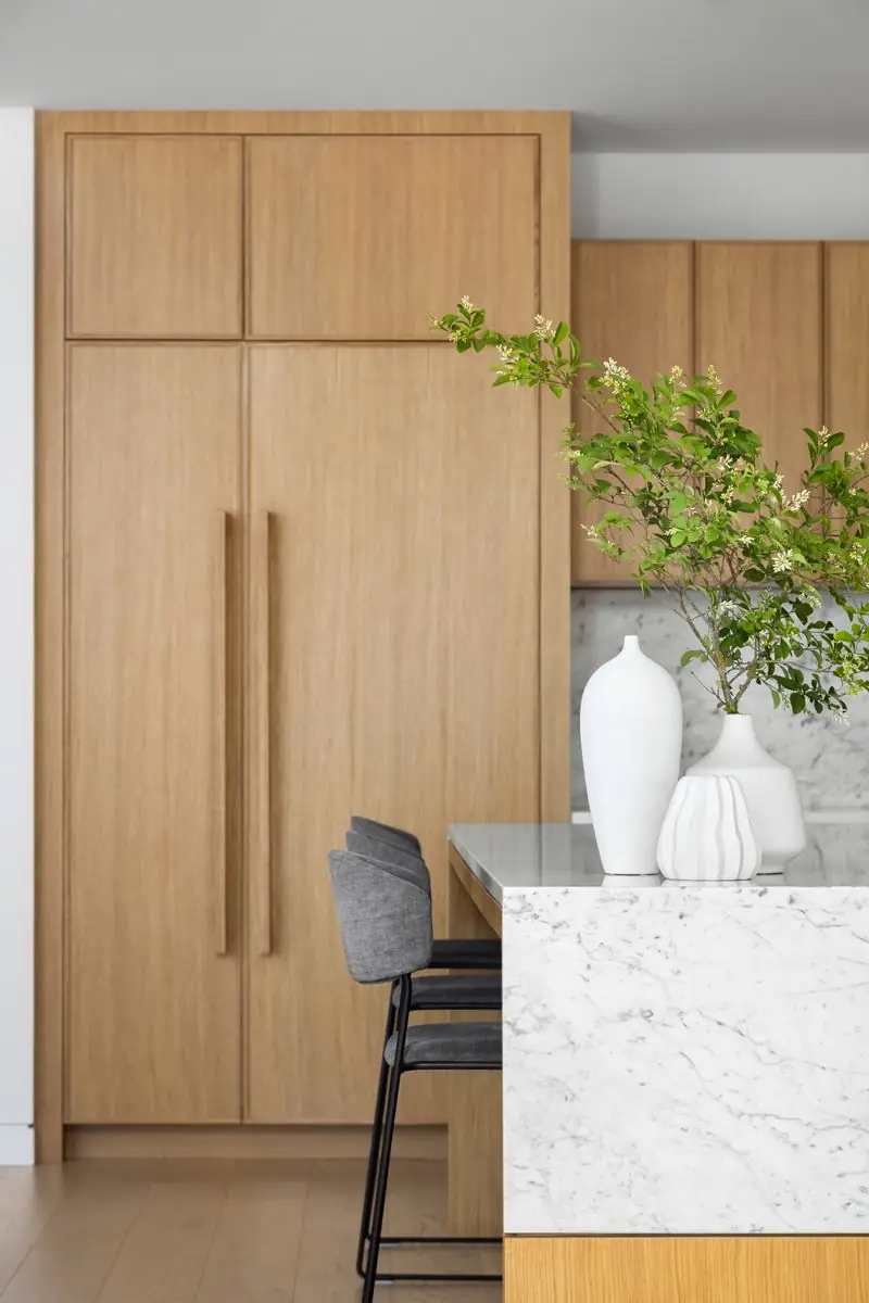 Oak-panelled fridge beside the marble island