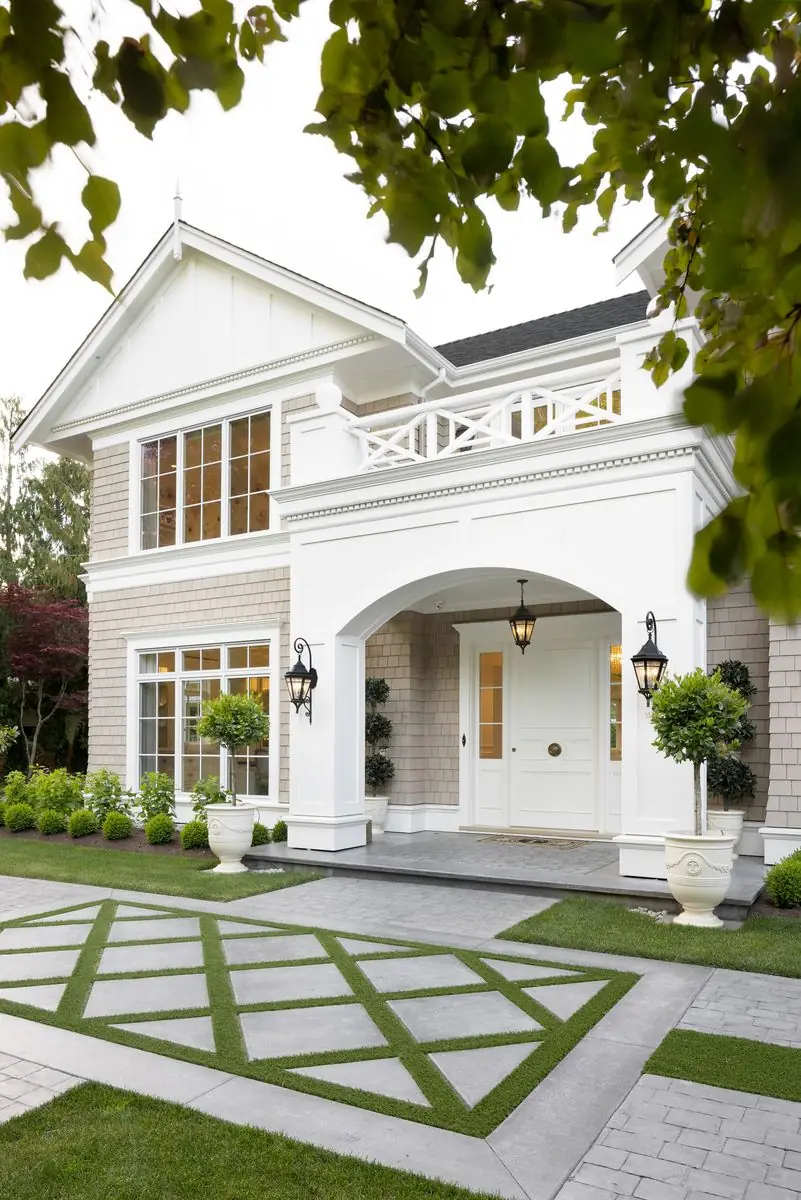 Front door under an arched portico, between lanterns