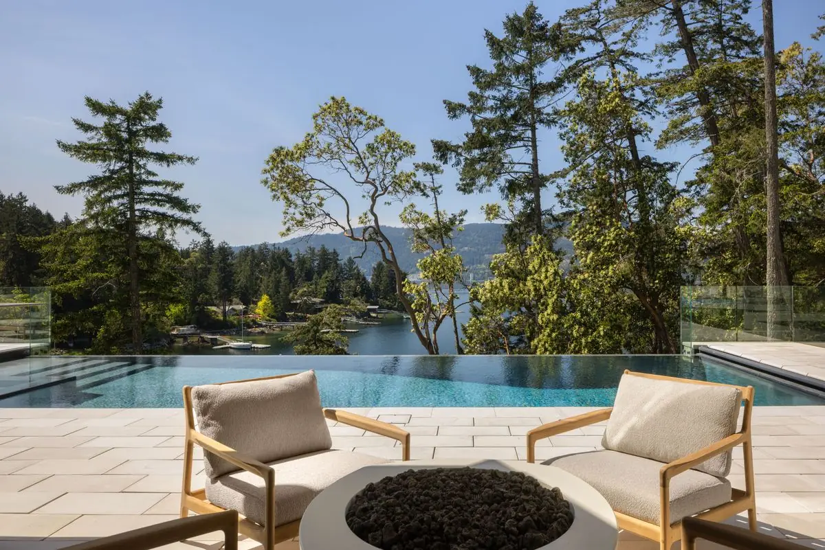 Lounge chairs and fire table by the infinity pool