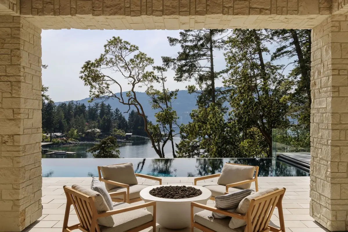 Covered terrace and fire table framed in stone