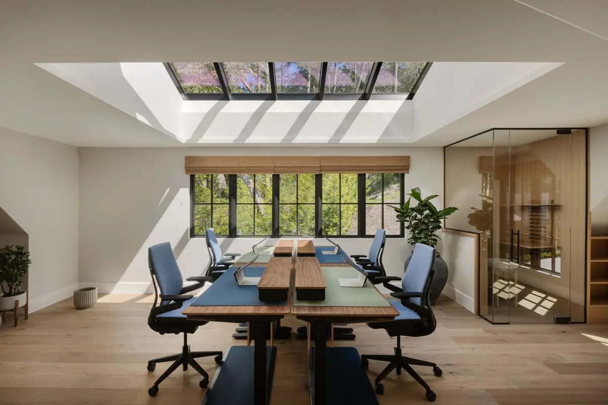 Office with skylights and a long desk