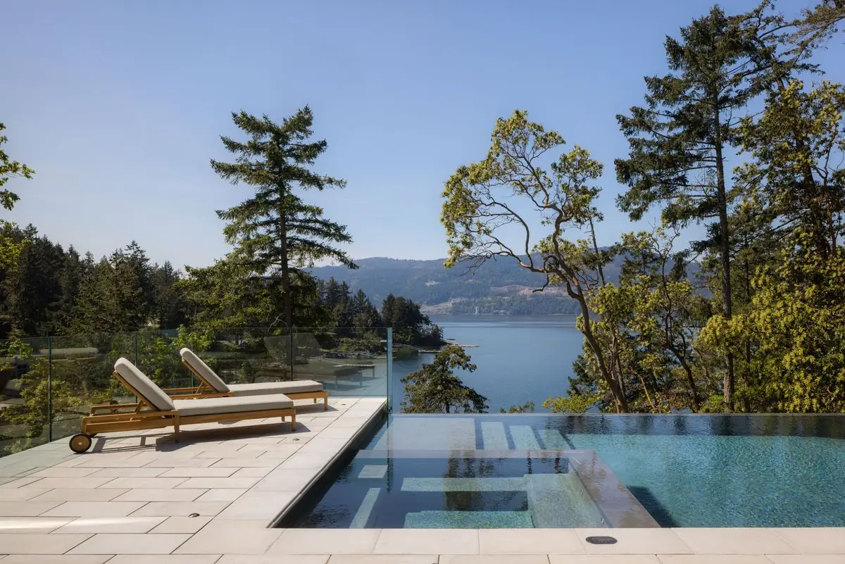 Infinity pool and loungers over the water