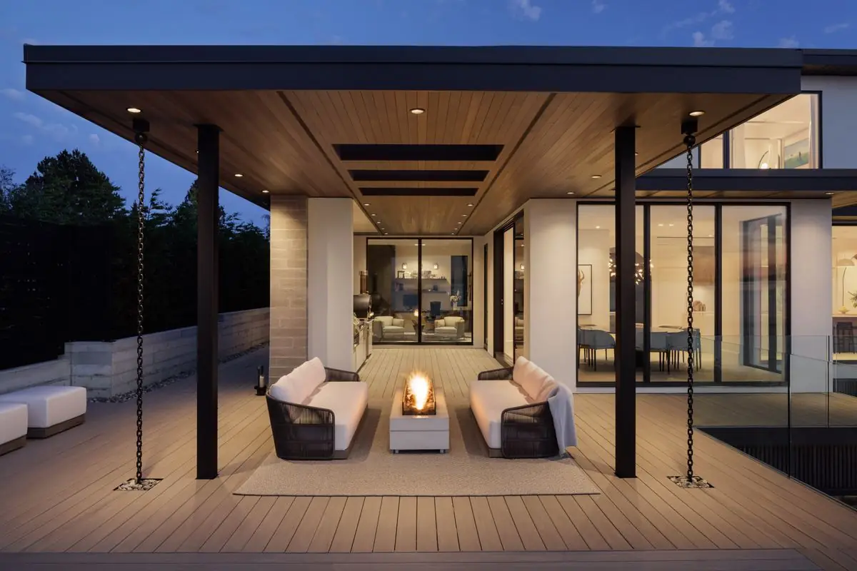 Two sofas around a fire table under the covered terrace