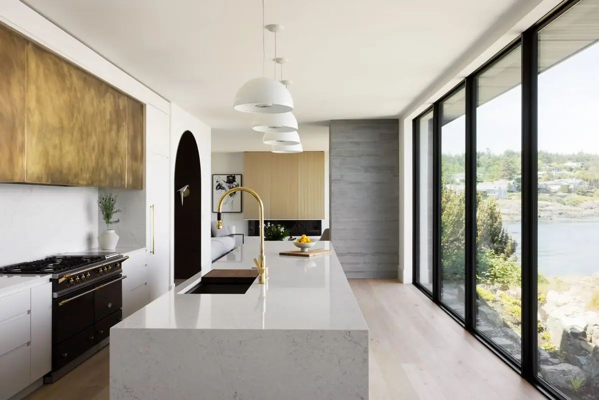Galley kitchen along a wall of glass above the water
