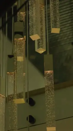 A vertical-reel still from 2029 Pinehurst, pendant lights.