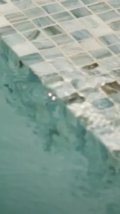 A vertical-reel still from 2060 Pinehurst, the pool edge.