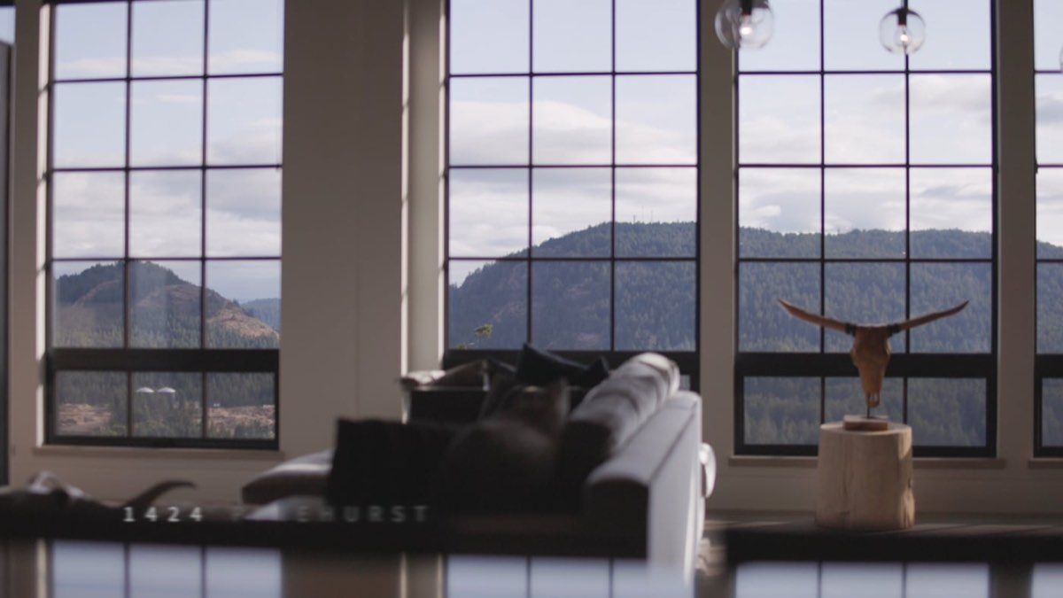 Great room with steel windows and a mountain view