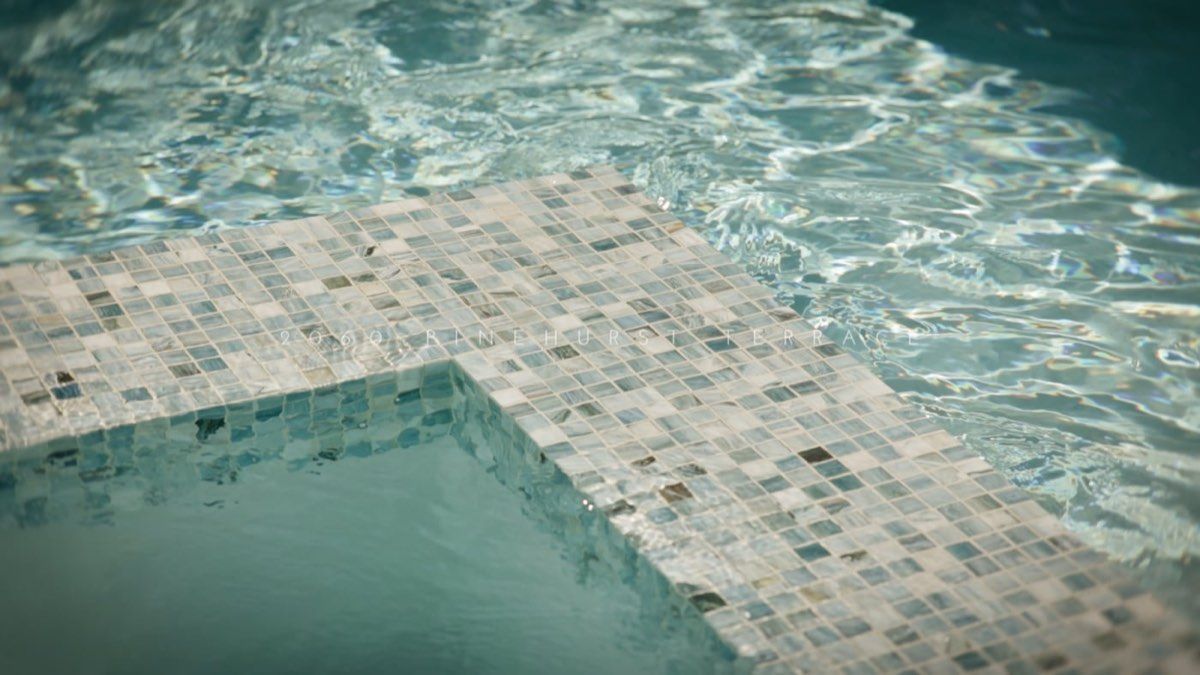 Sunlight on the water of a tiled pool